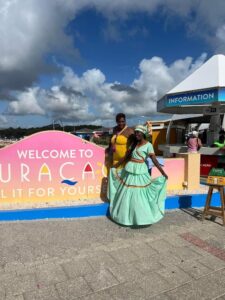 ladies standing in front of a sign